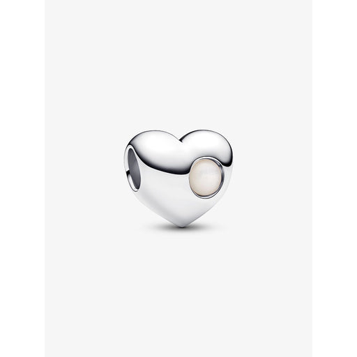 Close-up of a sterling silver heart-shaped Pandora charm with a round white stone on one side.