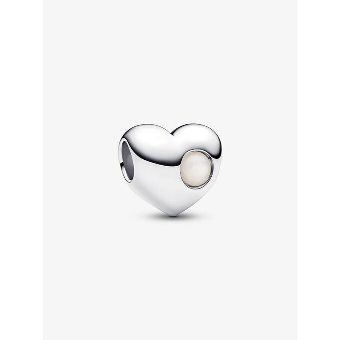 Close-up of a sterling silver heart-shaped Pandora charm with a round white stone on one side.