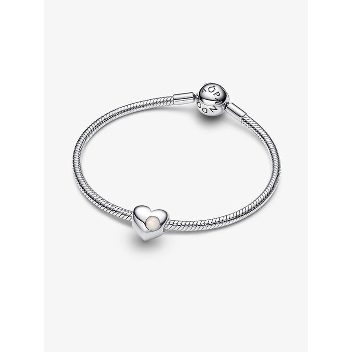 Sterling silver Pandora snake chain bracelet featuring a white stone heart charm on a plain background.