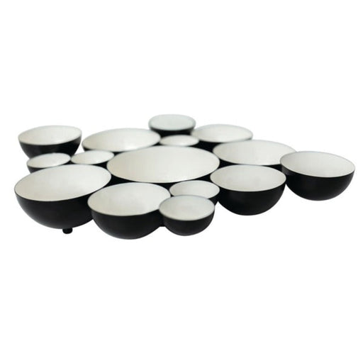 Set of black and white ceramic bowls arranged in a circular pattern on a white background