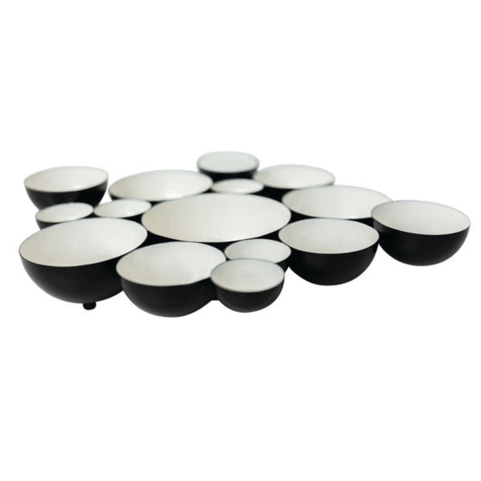Set of black and white ceramic bowls arranged in a circular pattern on a white background