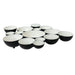 Set of black and white ceramic bowls arranged in a circular pattern on a white background