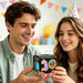 Man and woman holding a colorful ball toy with a box, surrounded by party decorations.
