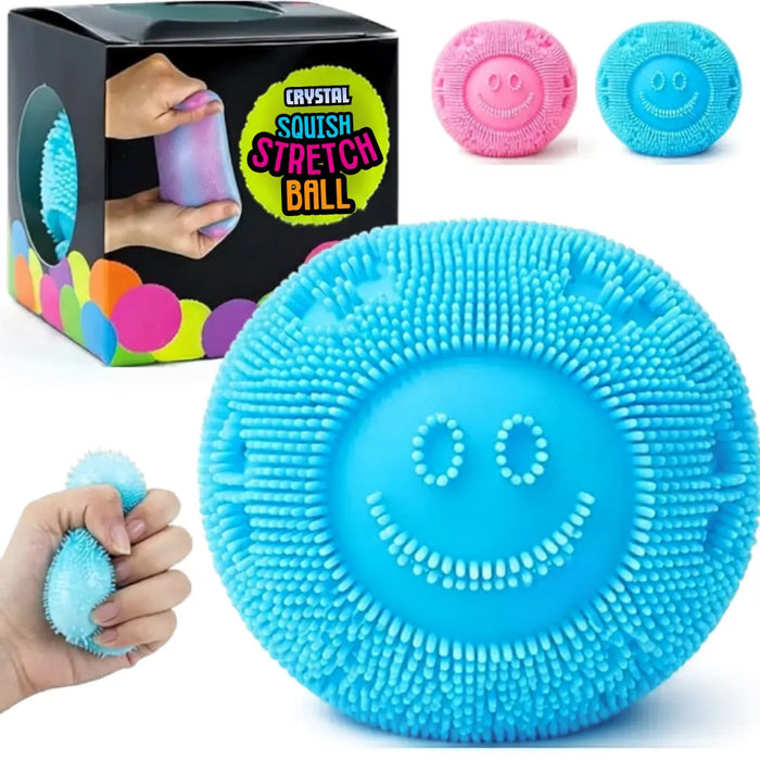 Blue squishy stretch ball with smiley face design, packaging, and additional balls in the background.