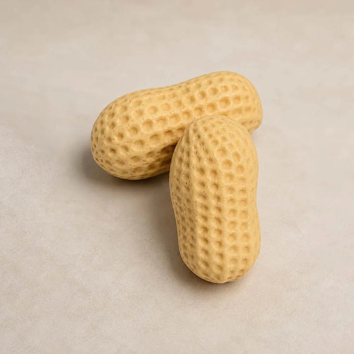 Two peanuts on a beige background