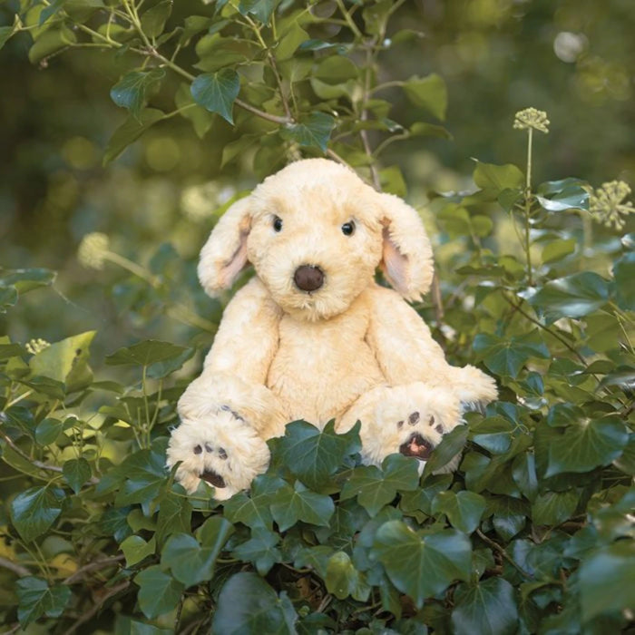 A plush dog figure sitting on a white background, emphasizing its texture and color.