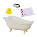 Toy bathtub with rubber duck, goggles, and towel on a white background