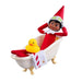 Elf on the Shelf figurine in a bathtub with a rubber duck and towel on a white background