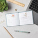A notebook adorned with three charming fox illustrations, showcasing their playful nature.