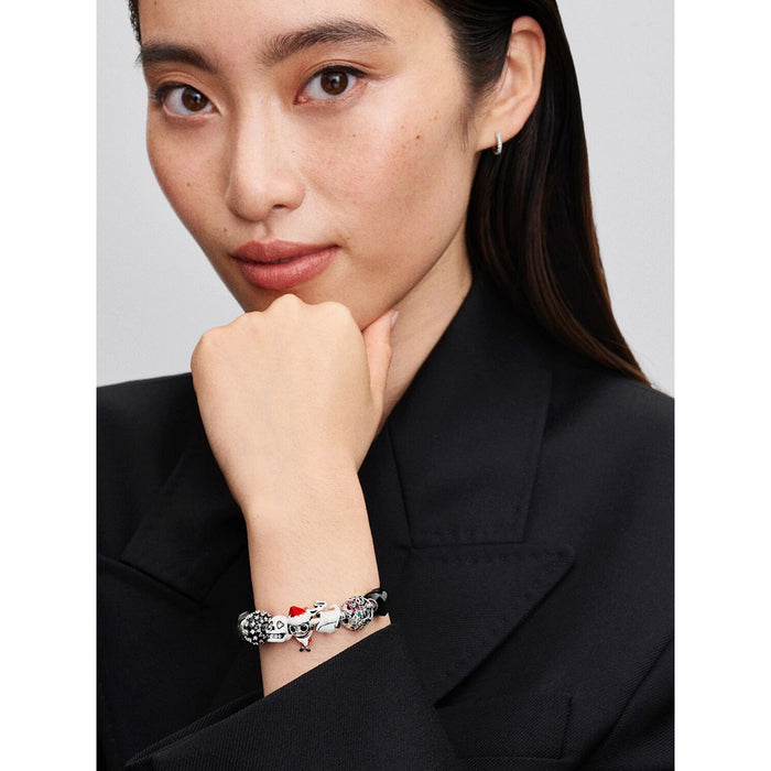 Woman wearing Pandora bracelet with Jack Skellington Santa charm styled with other Disney charms.