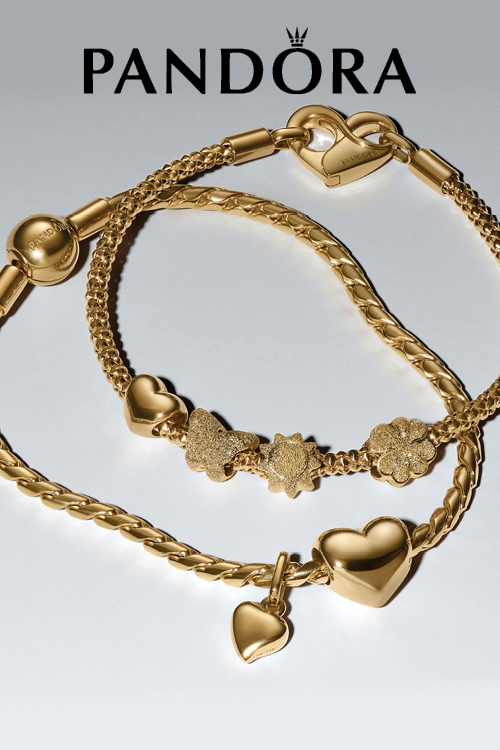 Gold Pandora bracelets with heart and star charms on a light gray background