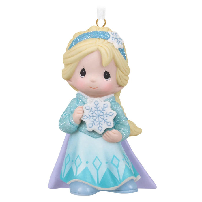 Ornament of a girl Elsa  in a blue dress holding a snowflake, on a white background