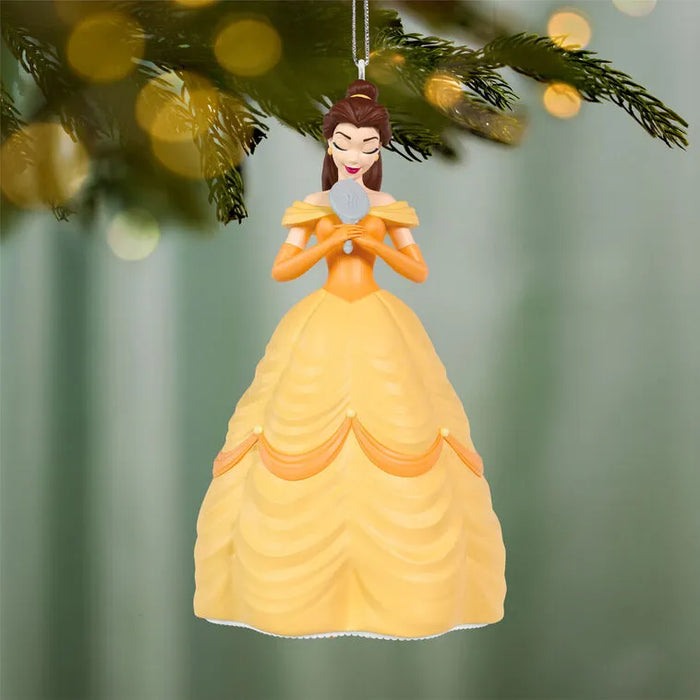Belle Disney ornament suspended on pine branch with golden bokeh lights and festive background