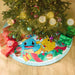 Light blue Pokémon holiday tree skirt styled under decorated Christmas tree with lights and ornaments