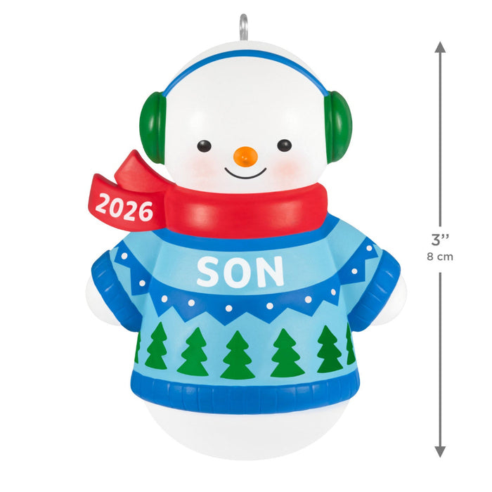 Christmas ornament of a snowman wearing a blue sweater with 'SON' and a red scarf, featuring the year '2026'.