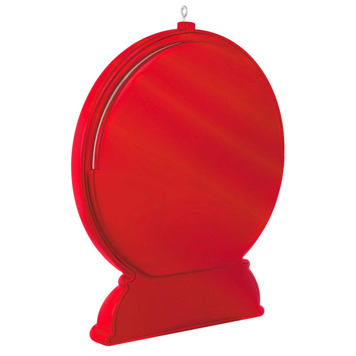 Back view of red plastic Hallmark keepsake ornament showing glossy texture, seam line, and hanging loop