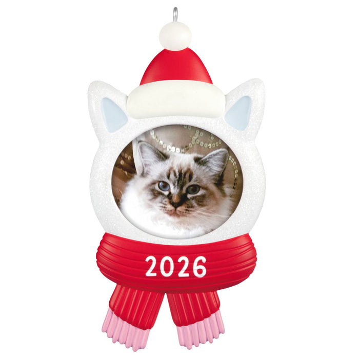 Cat-shaped Christmas ornament with a picture of a cat, red scarf, and Santa hat on a white background.