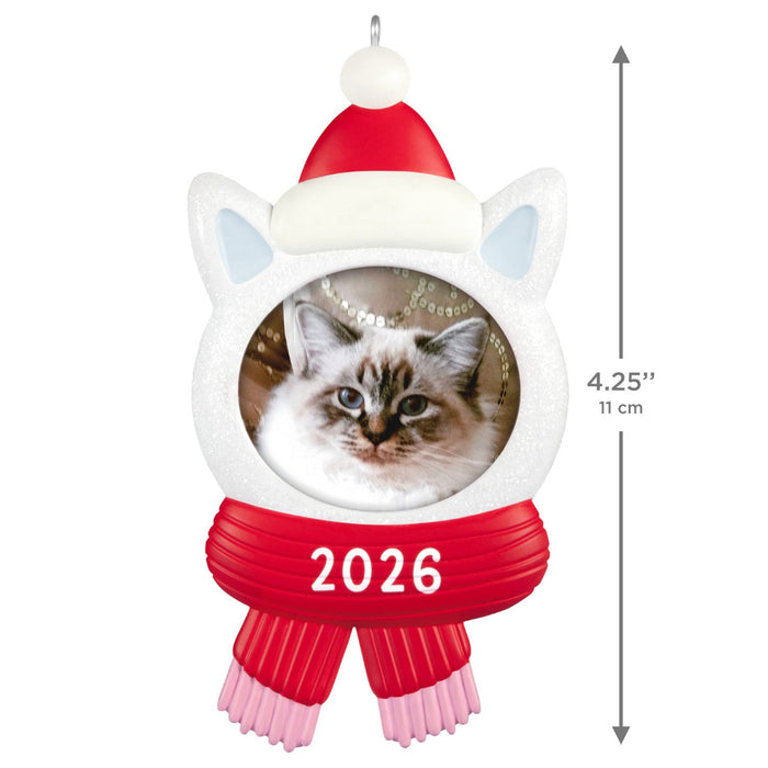 Cat-shaped ornament with a picture of a cat, red hat, and scarf with '2026' printed on it, on a white background.
