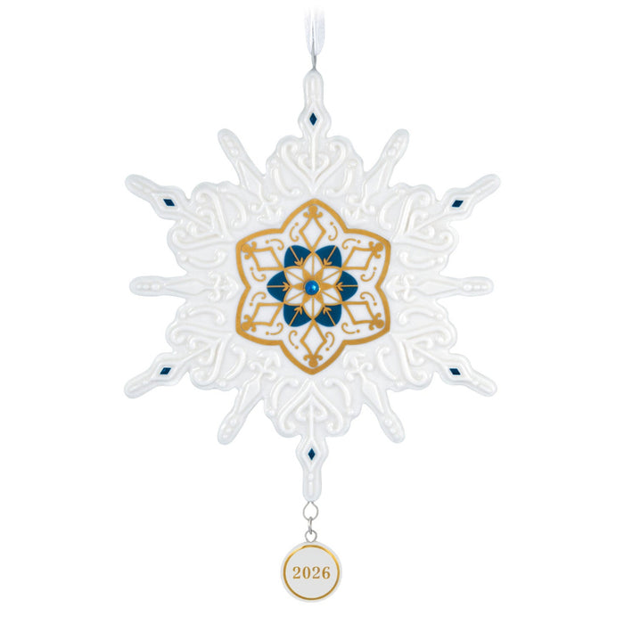 Decorative snowflake ornament with gold and blue design on a white background