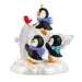 Ornament with penguins and a bird on a snowy base