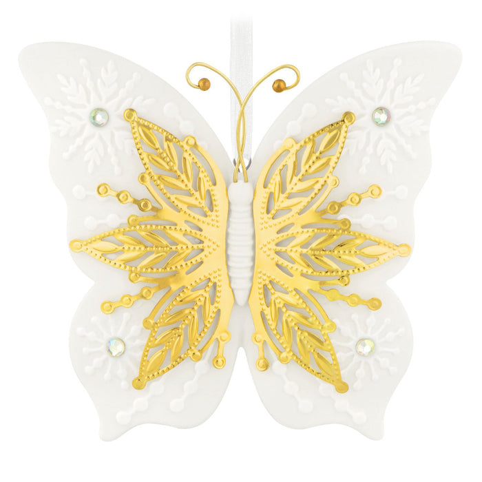 Butterfly-shaped decorative item with gold and white wings on a white background