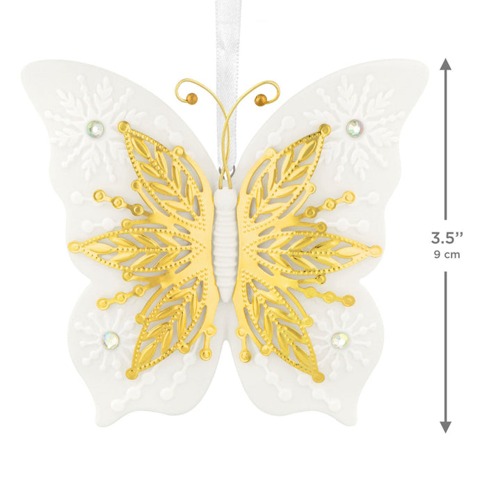 Butterfly-shaped decorative item with gold detailing on a white background