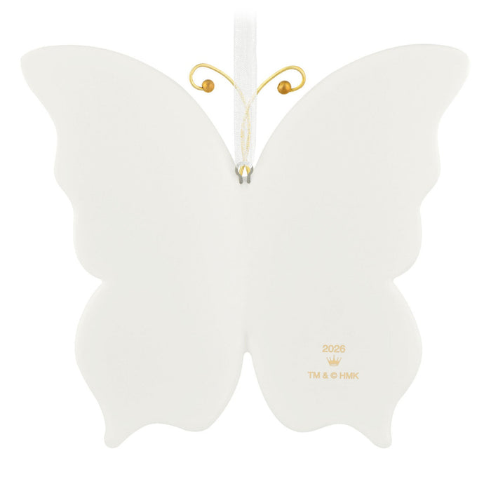 White butterfly-shaped product with gold accents on a white background