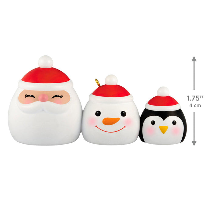 Three Christmas-themed figurines, including a Santa Claus, snowman, and penguin, with size measurement indicated.