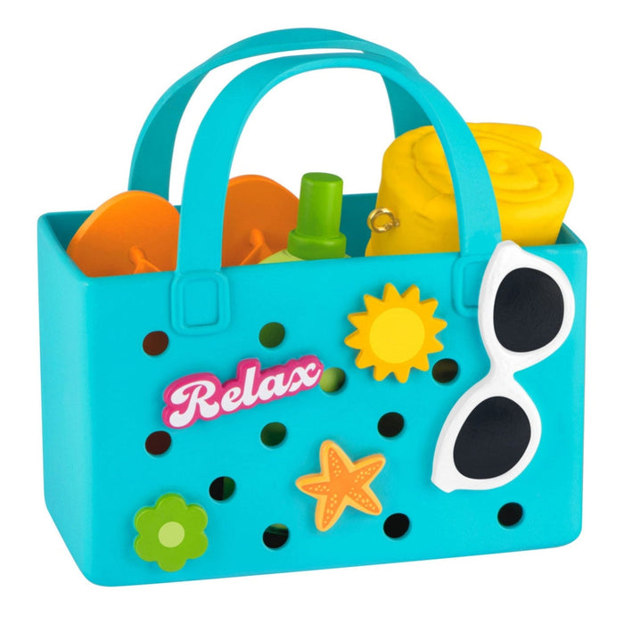 Toy sandcastle set with a blue carrier labeled 'Relax' on a white background