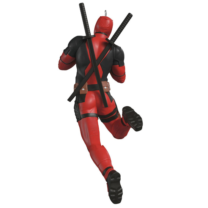 Deadpool action figure in red and black costume with weapons on a white background