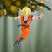 Character figurine in orange and blue outfit hanging from a Christmas tree.