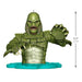 Green creature figurine with measurements on a white background