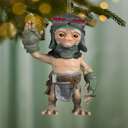 Star Wars Anzellan droidsmith ornament hanging from pine branch with golden bokeh background lights