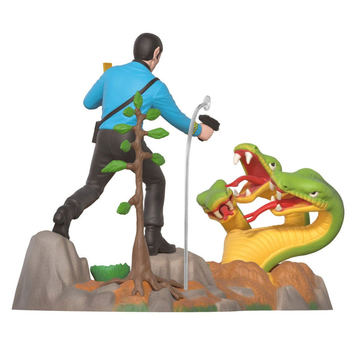Action figure of a character with a tree and a large dragon-like creature on a white background