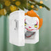 Decorative Christmas ornament with a character in a white box against a festive background