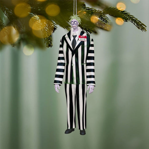 Beetlejuice Beetlejuice Bob ornament hanging on Christmas tree with lights