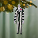 Beetlejuice Beetlejuice Bob ornament hanging on Christmas tree with lights