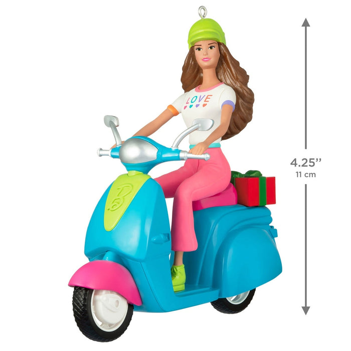 4.25 inch tall plastic Barbie Christmas ornament on scooter with red gift box detail