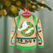 Ghostbusters light-up sweater ornament against blurred pine branches with bokeh lights