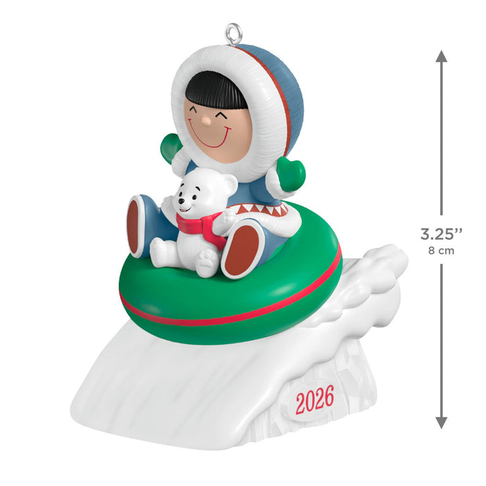 Christmas ornament with a child and dog on an inner tube, featuring the year 2026.