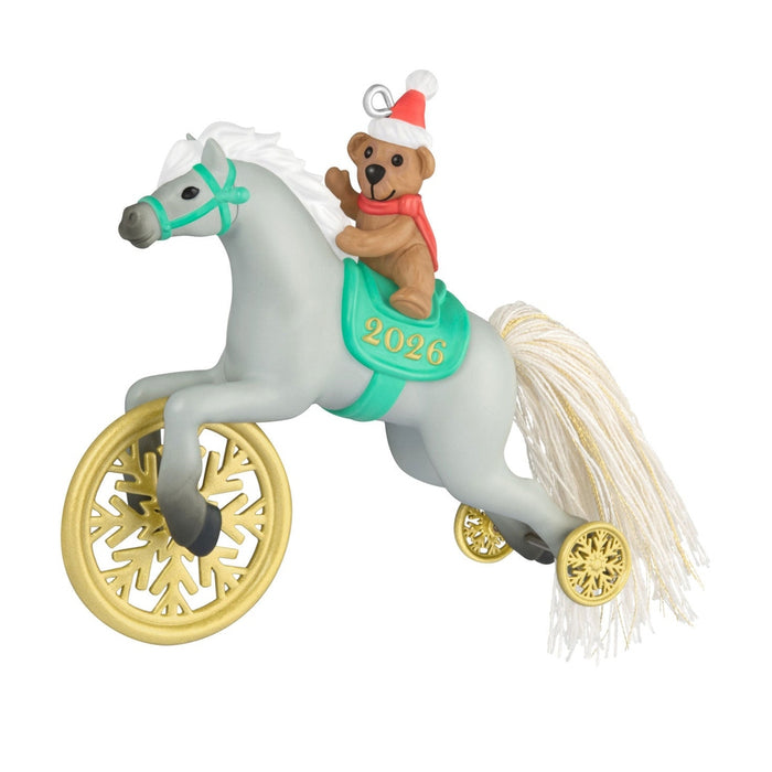 Close-up of Hallmark 2026 ornament featuring gray pony bear rider and gold snowflake wheels