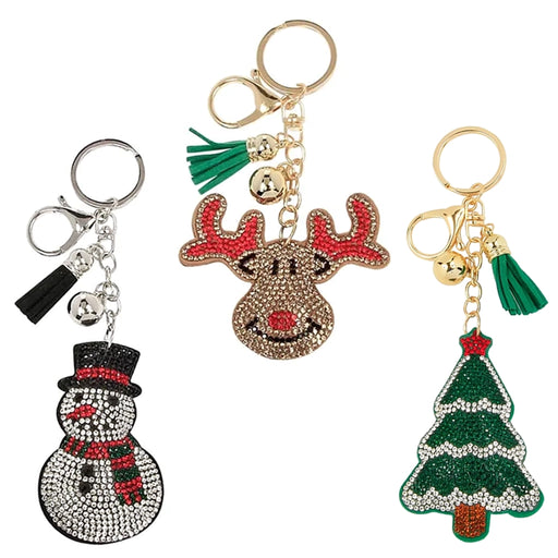 Three festive keychains shaped like a snowman, reindeer, and Christmas tree on a white background.