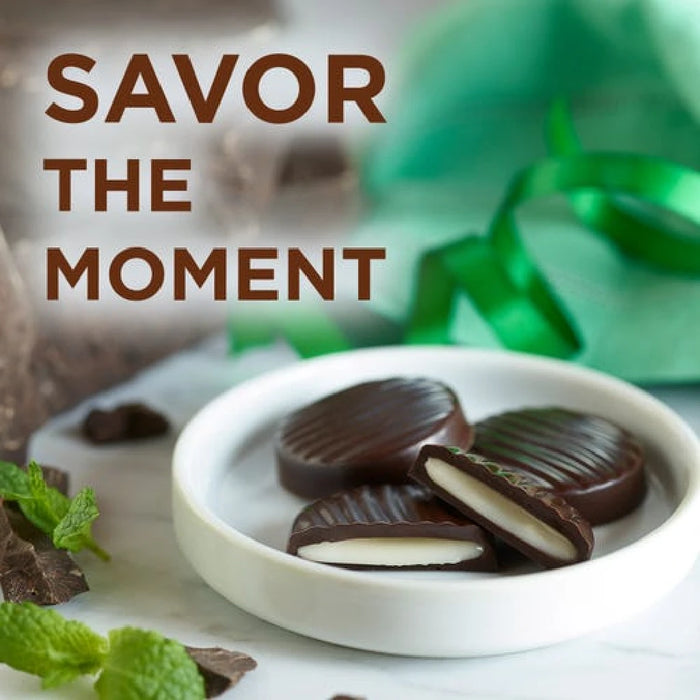 Chocolate-covered treats on a white plate with mint leaves, text 'SAVOR THE MOMENT' in the background.