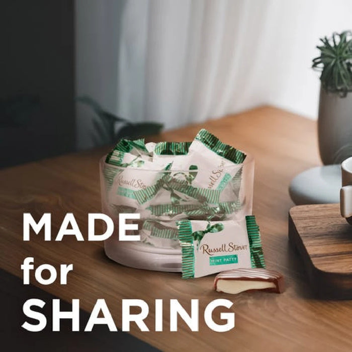 Packaged snacks on a wooden table with 'Made for Sharing' text
