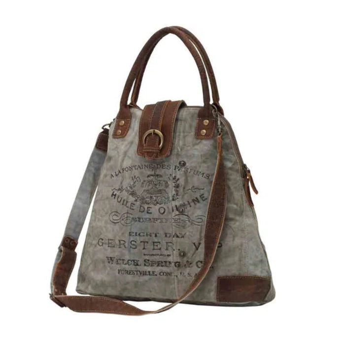 The Myra Bag Gerster Shoulder Bag features upcycled woven canvas with rich genuine leather accents. 