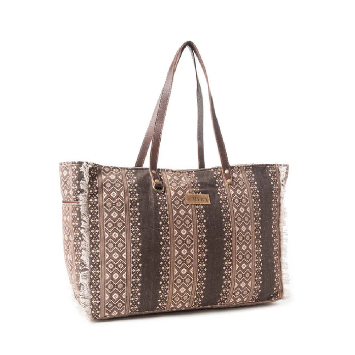 A patterned brown and white tote bag, showcasing a unique design suitable for everyday use and fashion.