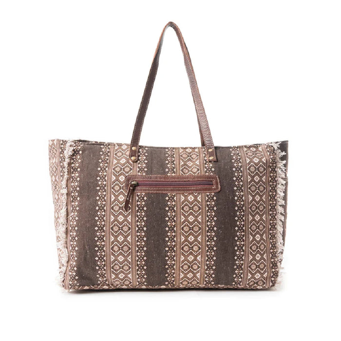 A brown and white tote bag with an intricate pattern, perfect for carrying essentials while adding a touch of style.