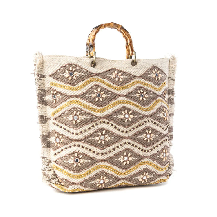 Stylish woven tote bag adorned with geometric shapes and gold accents, perfect for casual outings.