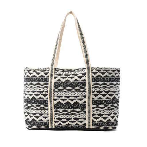 A tote bag featuring a design of alternating black and white stripes.