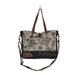 The Myra Bag Mystique Messenger Bag features upcycled woven canvas with rich leather accents. 